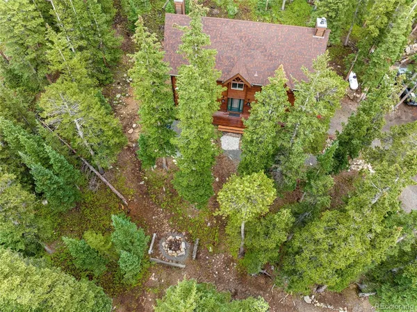 an aerial view of a house with a yard