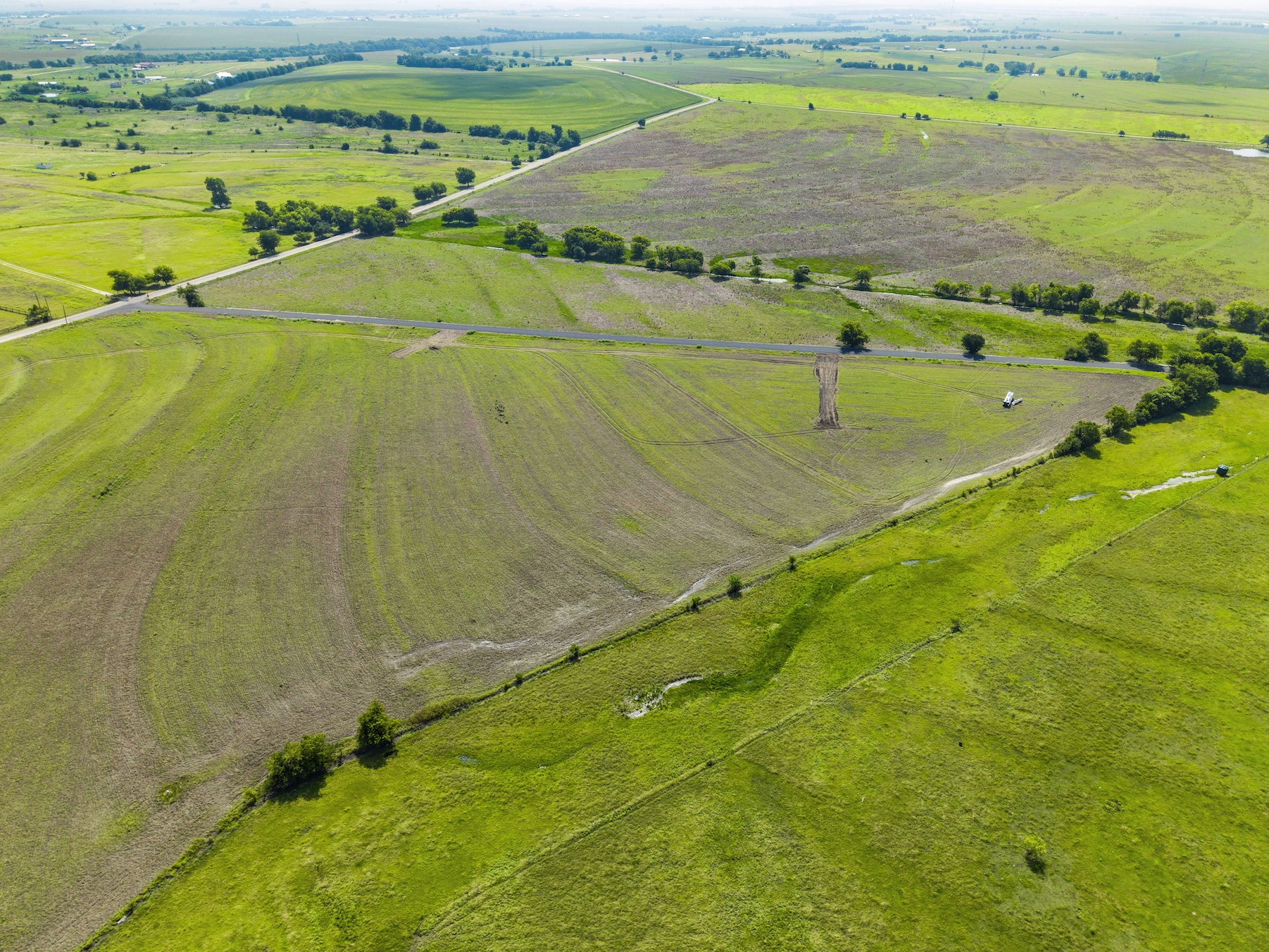 1 County Road 327 Road Granger, TX 76530 - Photo 23 of 27 Vast green pastures and rolling hillsides stretch across the open countryside landscape.