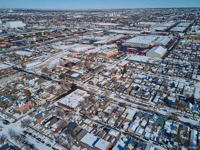 an aerial view of a residential houses with yard and ocean view
