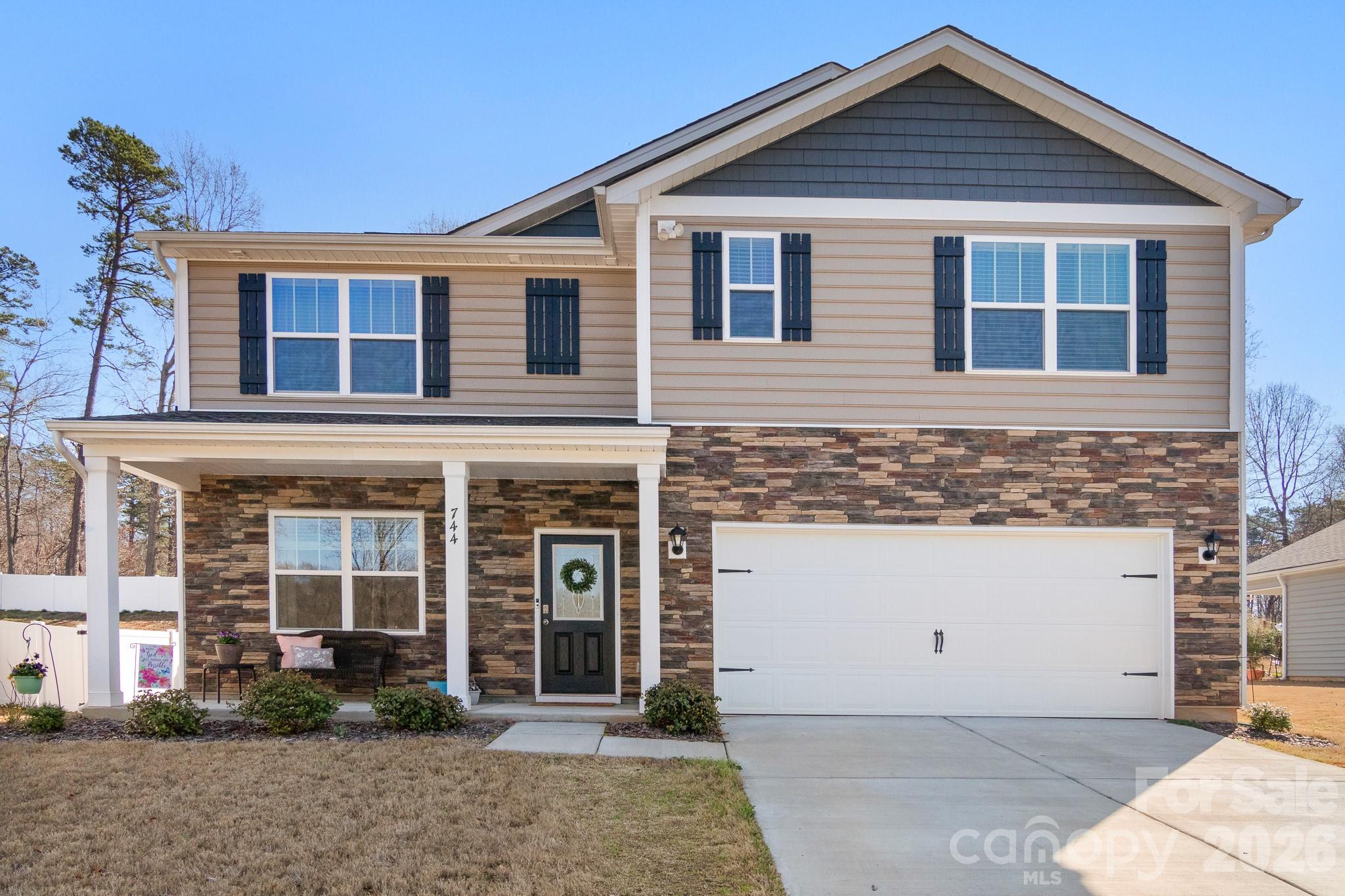 744 Saddlebred Lane Locust, NC 28097 - Photo 1 of 47 a front view of a house with garden