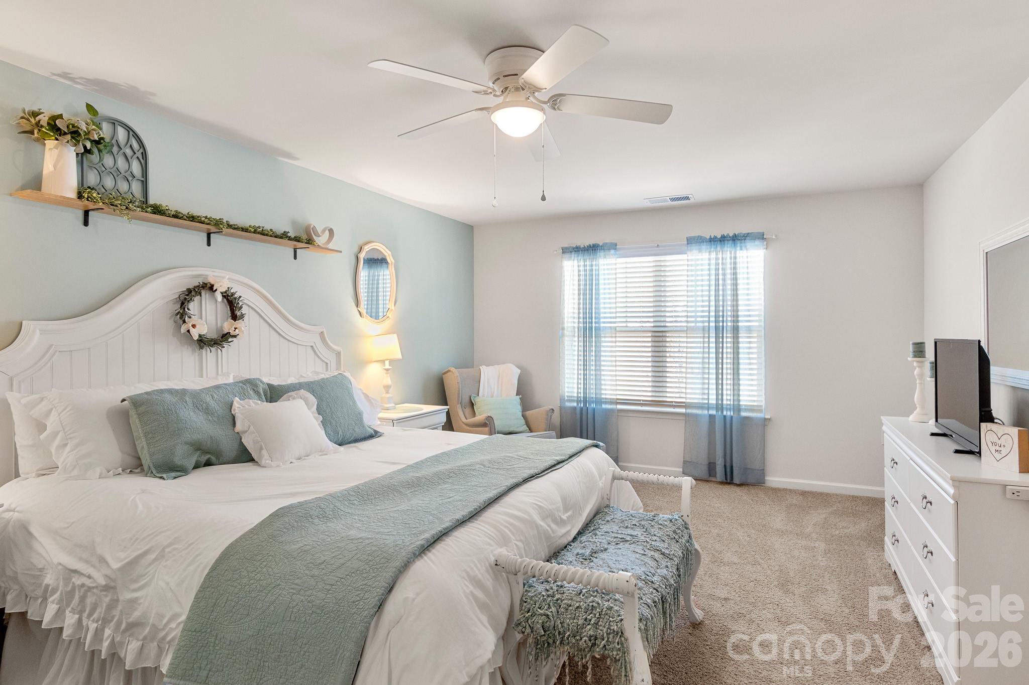 744 Saddlebred Lane Locust, NC 28097 - Photo 24 of 47 a bedroom with a bed and a flat screen tv