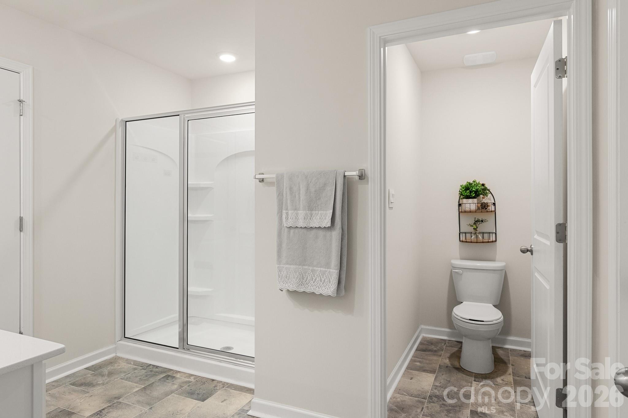 744 Saddlebred Lane Locust, NC 28097 - Photo 27 of 47 a bathroom with a toilet and a shower