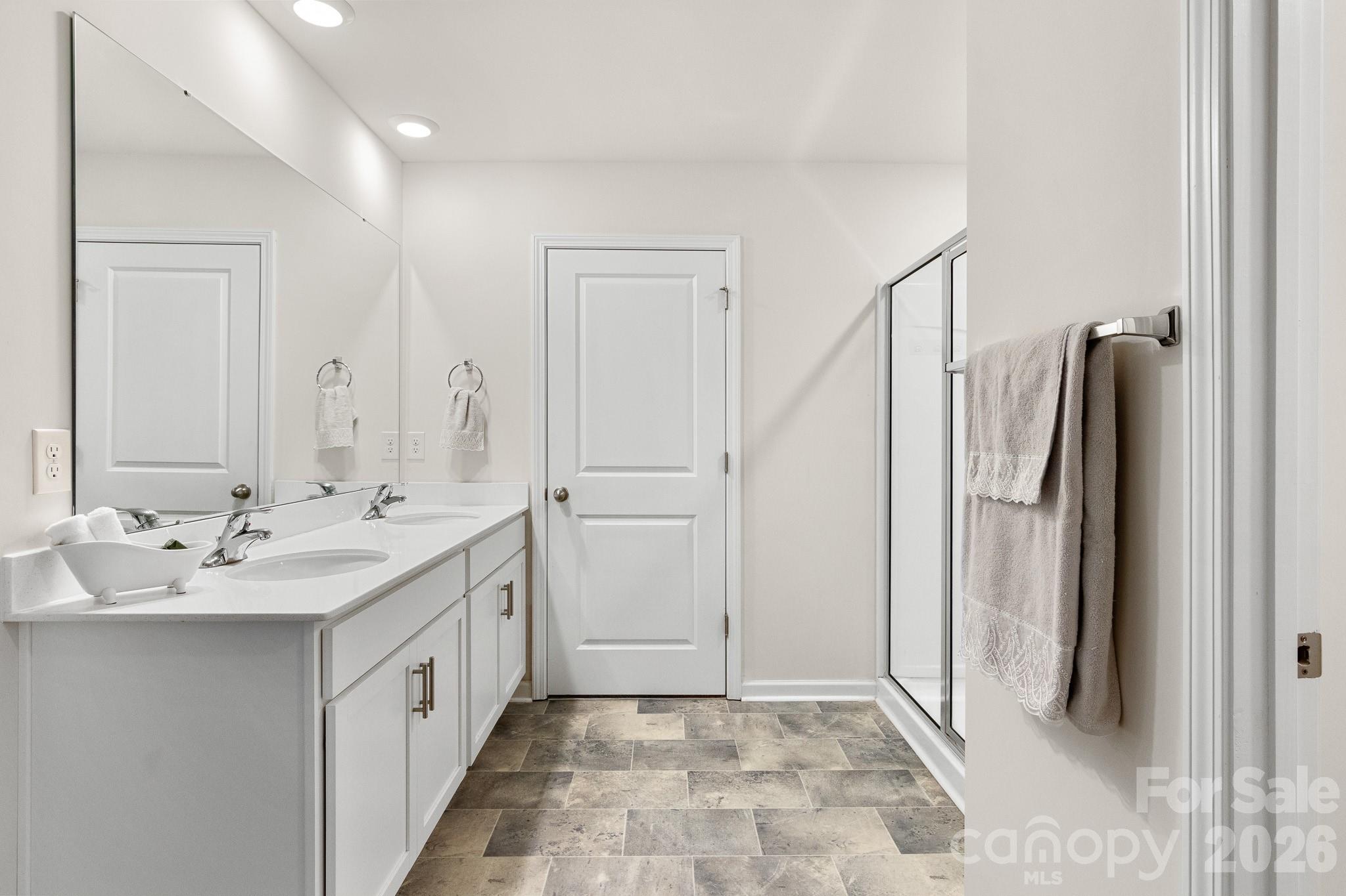 744 Saddlebred Lane Locust, NC 28097 - Photo 28 of 47 a spacious bathroom with a double vanity sink and a mirror