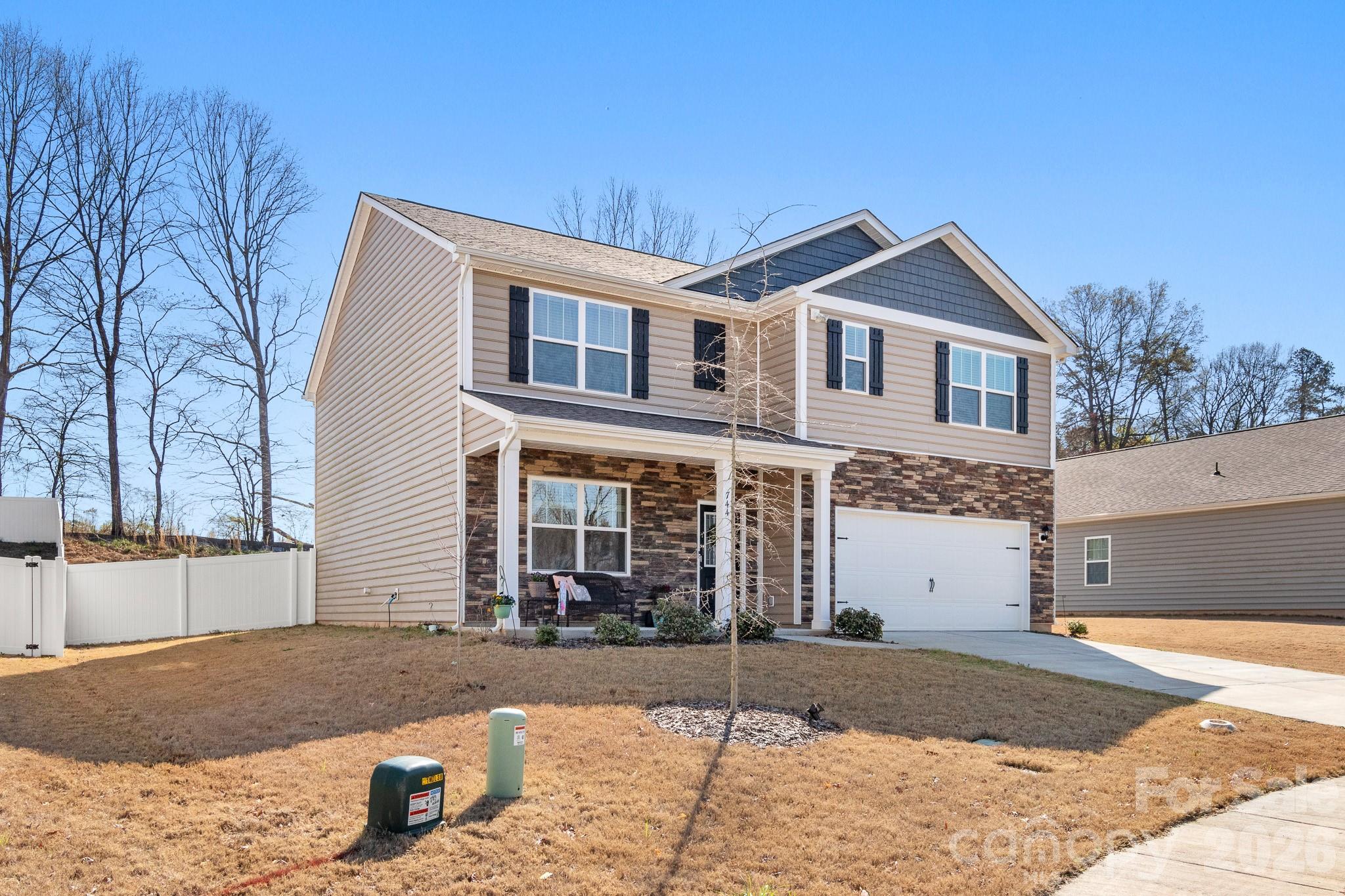 744 Saddlebred Lane Locust, NC 28097 - Photo 3 of 47 a front view of a house with a yard and garage