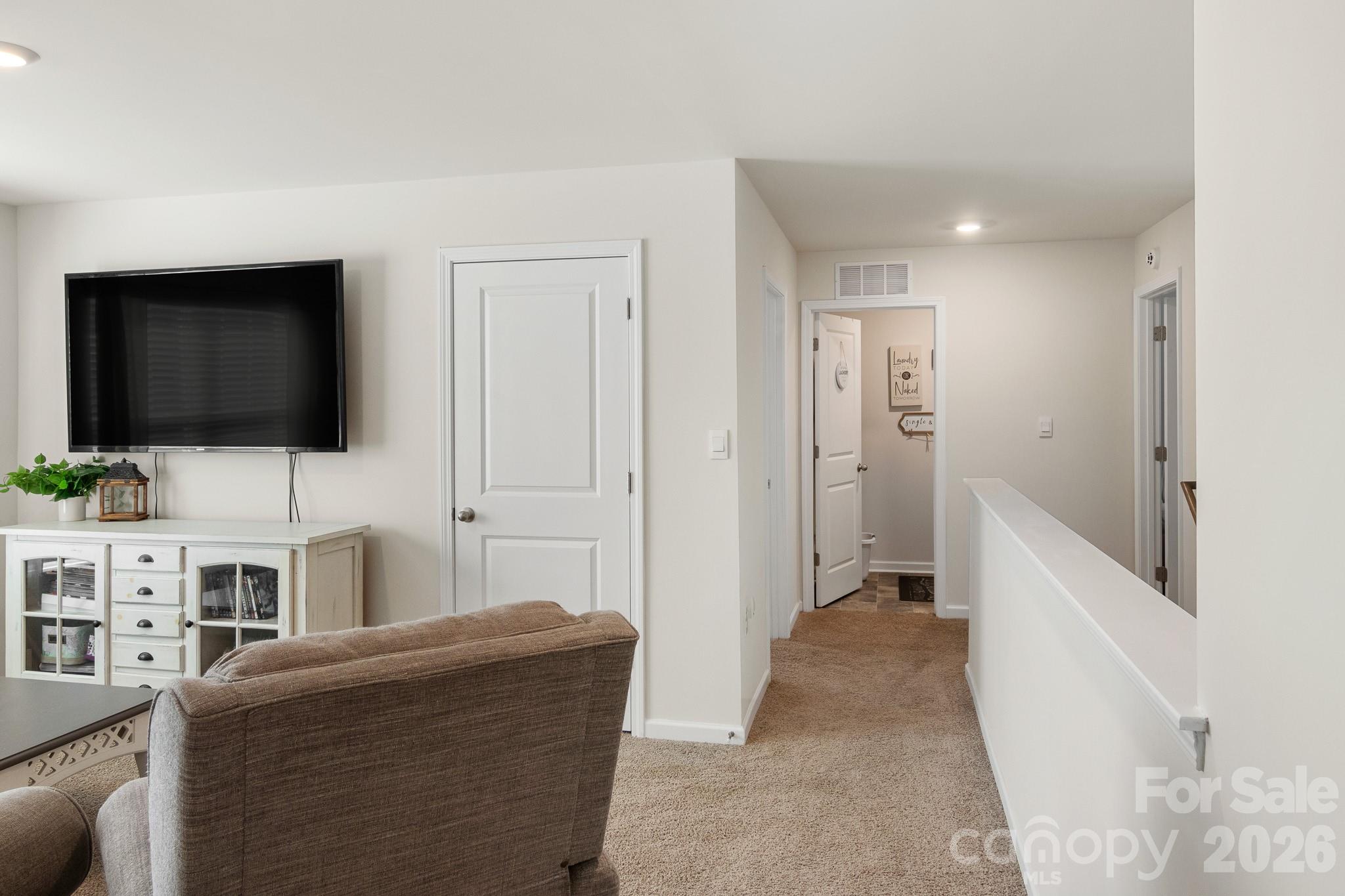 744 Saddlebred Lane Locust, NC 28097 - Photo 35 of 47 a living room with furniture and a flat screen tv