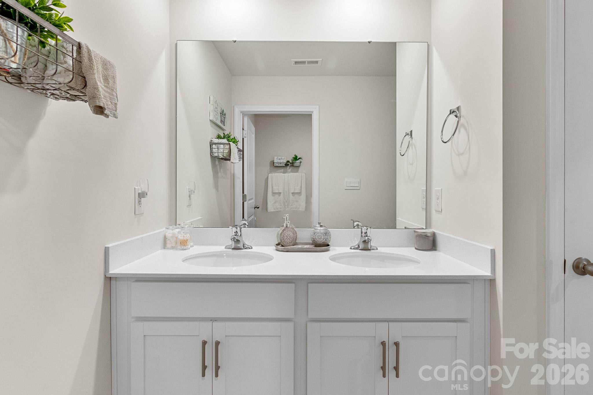 744 Saddlebred Lane Locust, NC 28097 - Photo 42 of 47 a bathroom with a sink vanity and a mirror