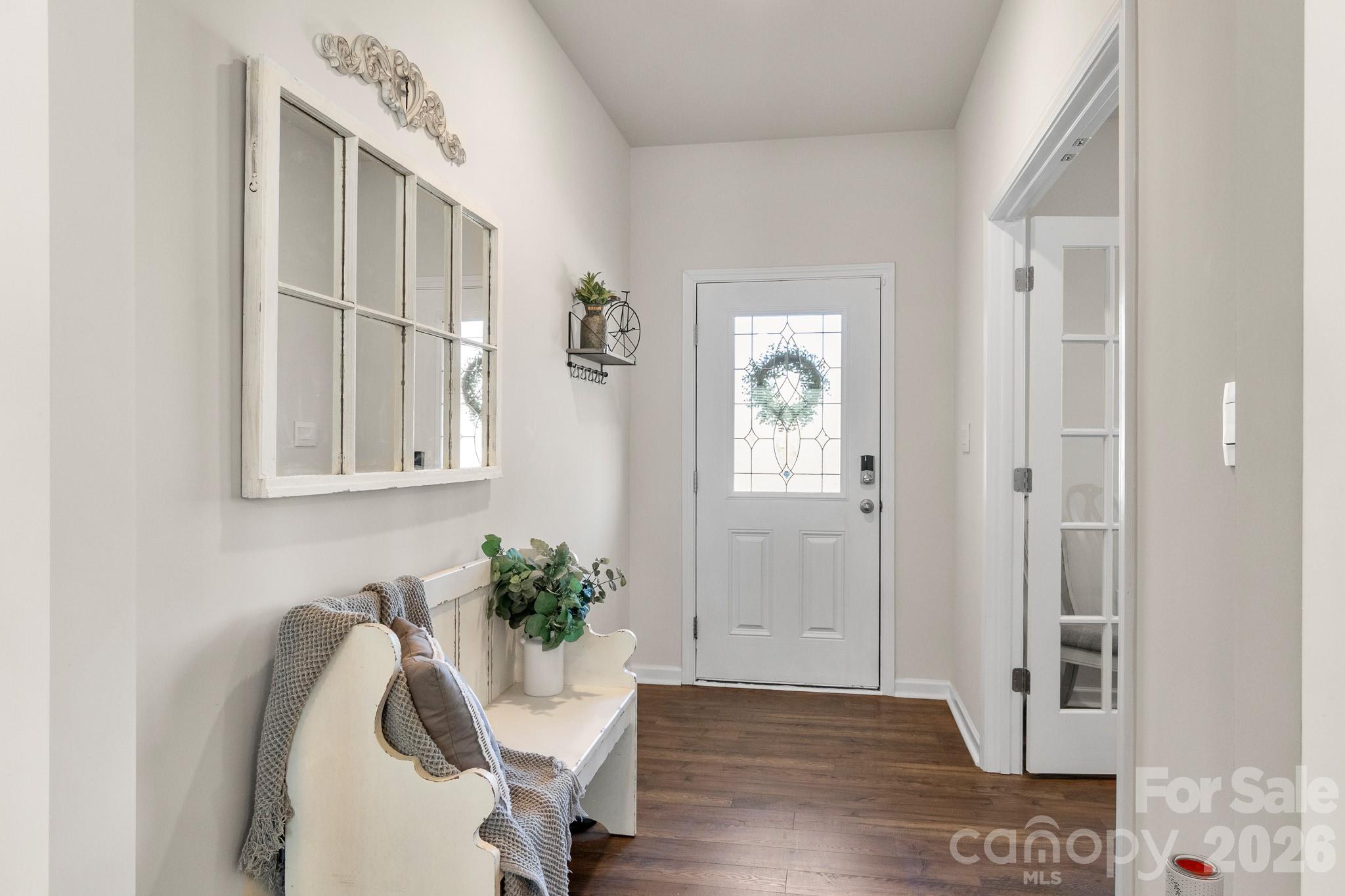 744 Saddlebred Lane Locust, NC 28097 - Photo 5 of 47 a view of a livingroom with wooden floor and a potted plant