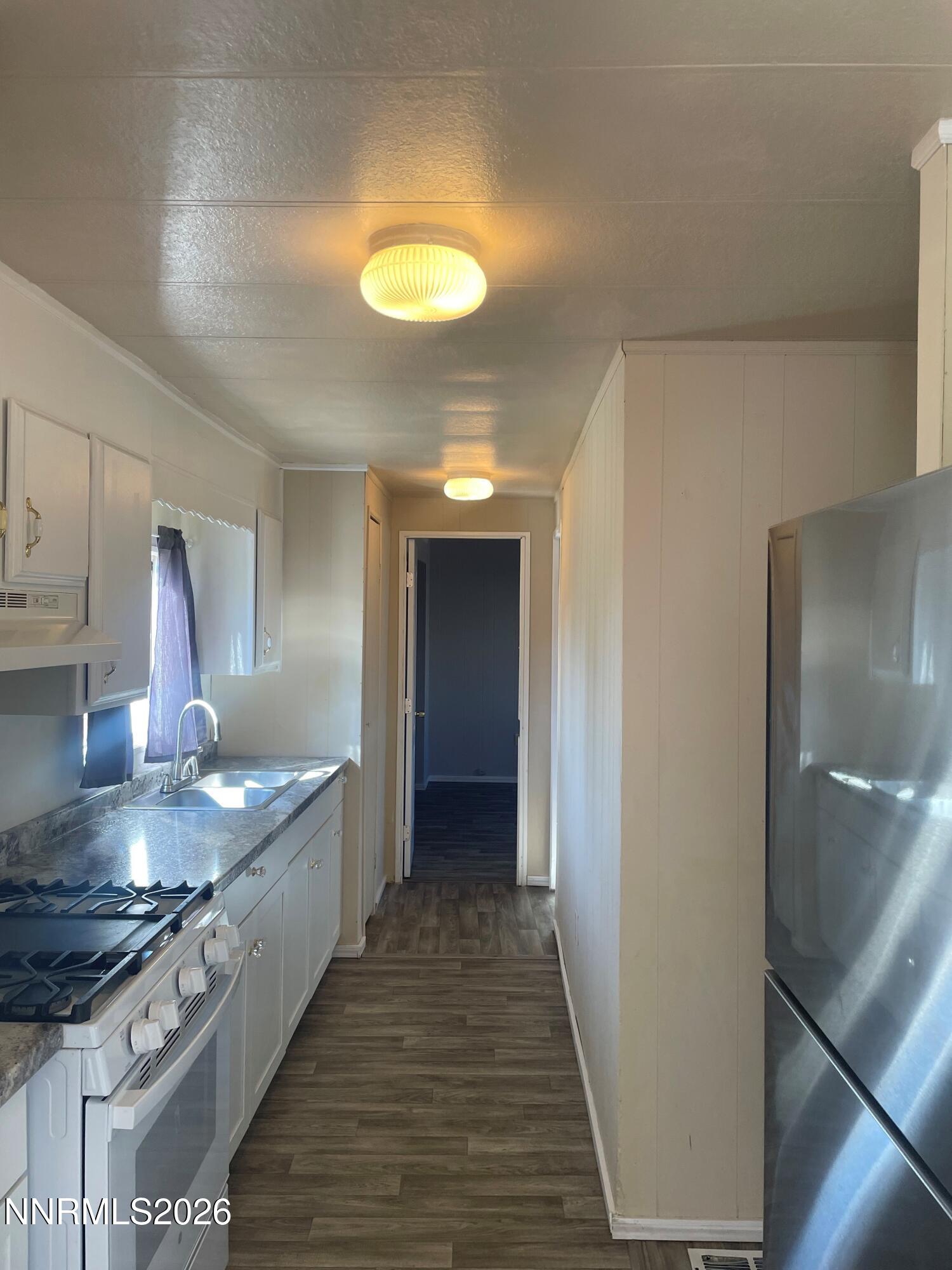 400 Mira Street Reno, NV 89521 - Photo 9 of 11 a kitchen with stainless steel appliances granite countertop a stove and a refrigerator