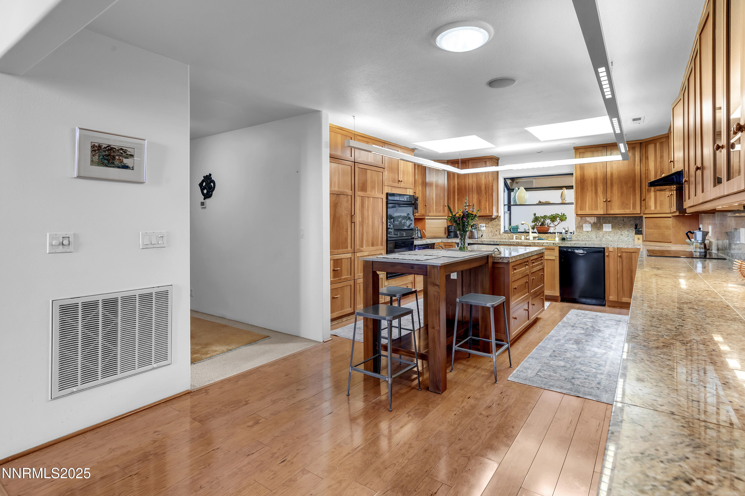 512 Island Avenue Reno, NV 89501 - Photo 14 of 30 a room with stainless steel appliances kitchen island granite countertop lots of furniture and wooden floors