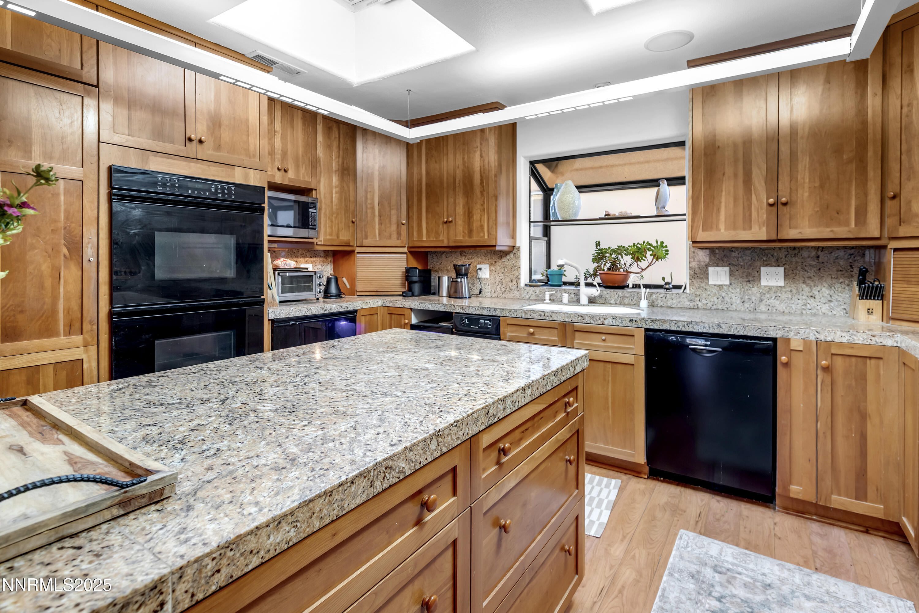 512 Island Avenue Reno, NV 89501 - Photo 18 of 30 a kitchen with stainless steel appliances granite countertop a sink stove and refrigerator
