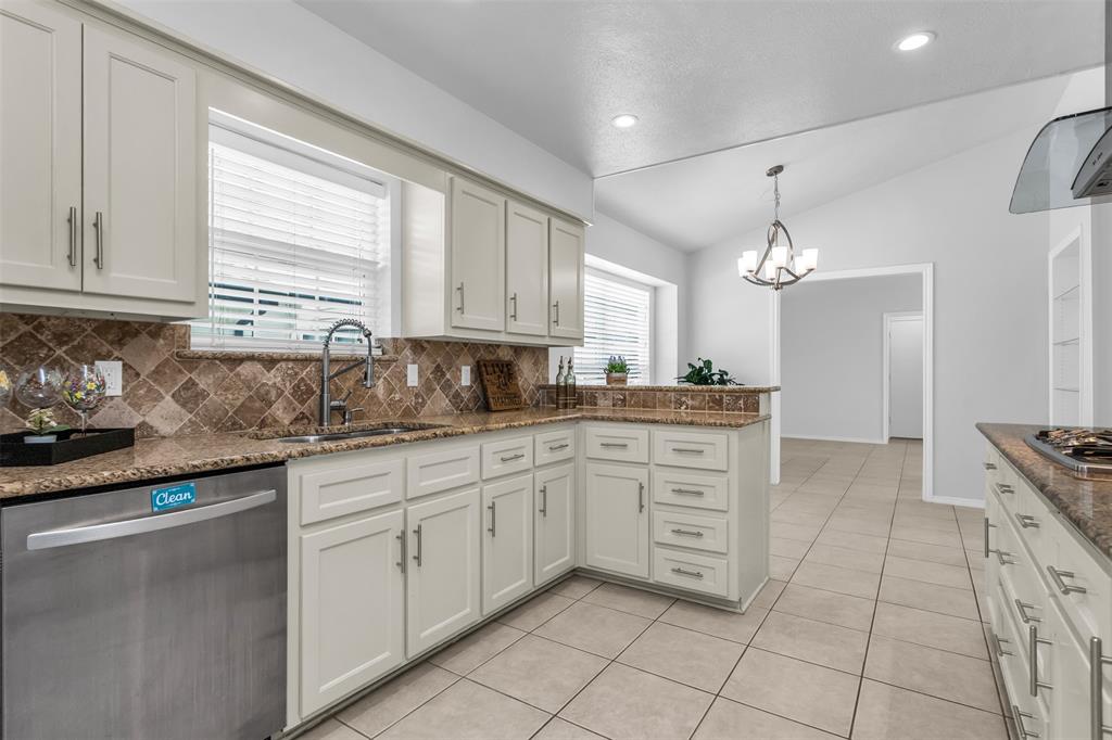 7233 Rustic Valley Drive Dallas, TX 75248 - Photo 8 of 21 a kitchen with cabinets appliances and a window