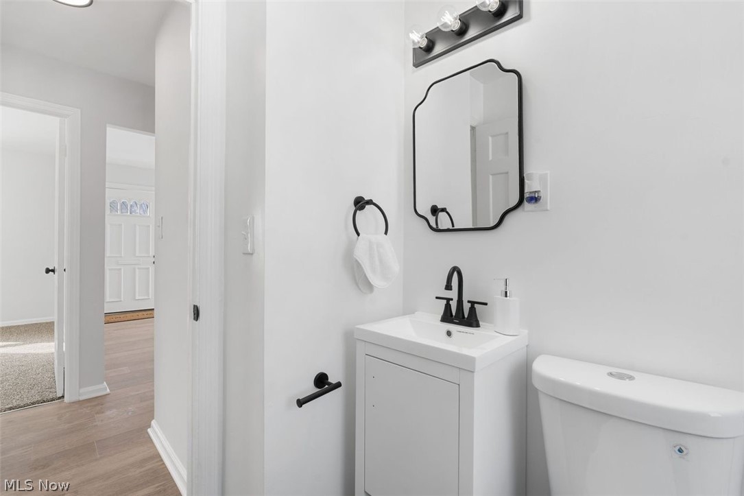 2401 Greenvale Road Cleveland, OH 44121 - Photo 22 of 25 Half bath featuring vanity and light wood-style flooring