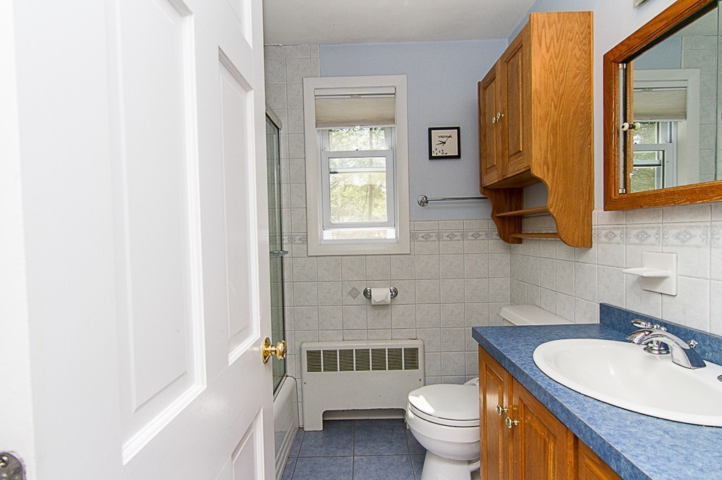 88 Selwyn Road Newton, MA 02461 - Photo 11 of 26 a bathroom with a toilet a sink and a mirror