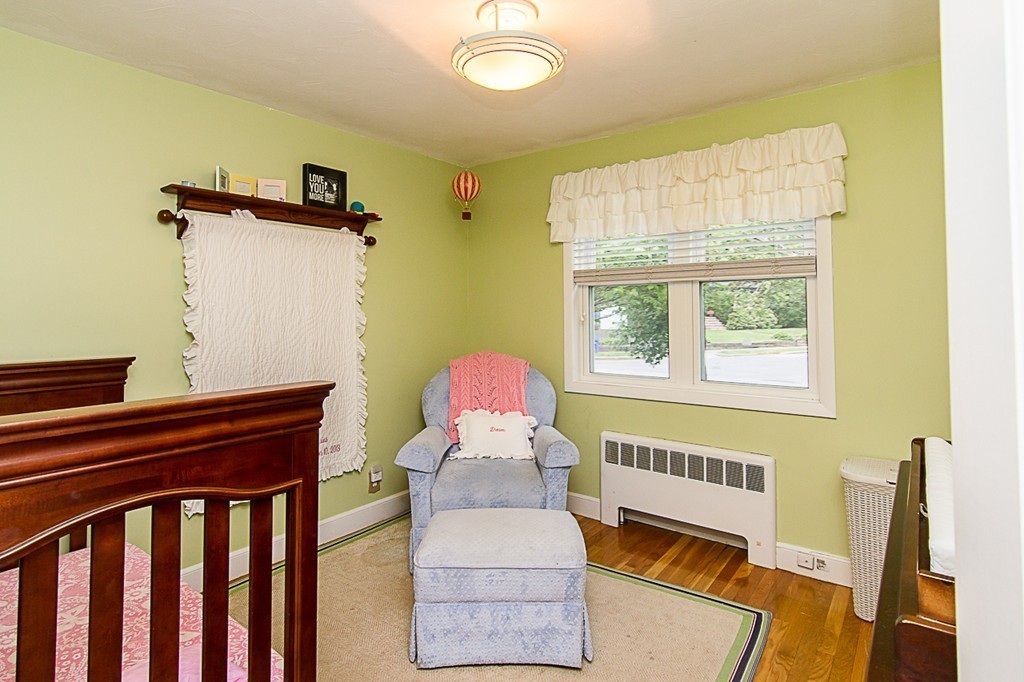 88 Selwyn Road Newton, MA 02461 - Photo 19 of 26 a bedroom with a bed and wooden floor