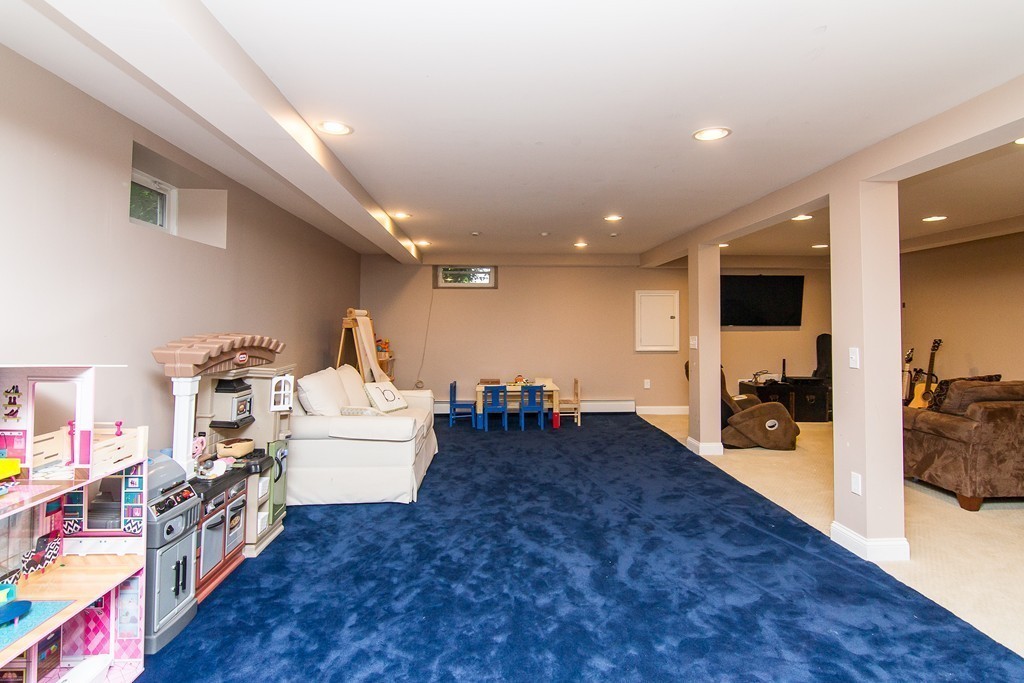 88 Selwyn Road Newton, MA 02461 - Photo 21 of 26 a living room with furniture and a flat screen tv