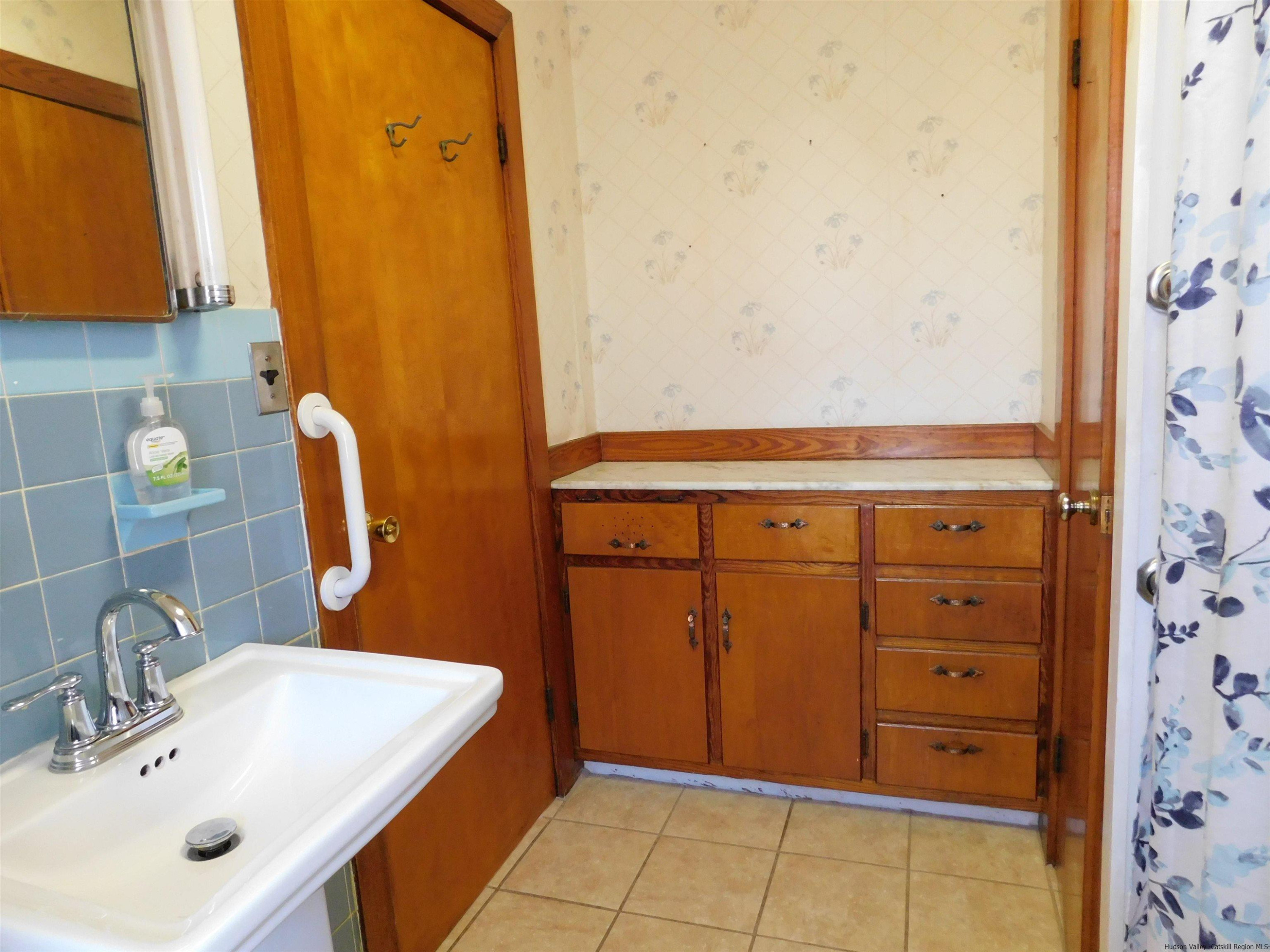 145 Sportsman Road Napanoch, NY 12458 - Photo 11 of 31 a bathroom with a sink and a mirror