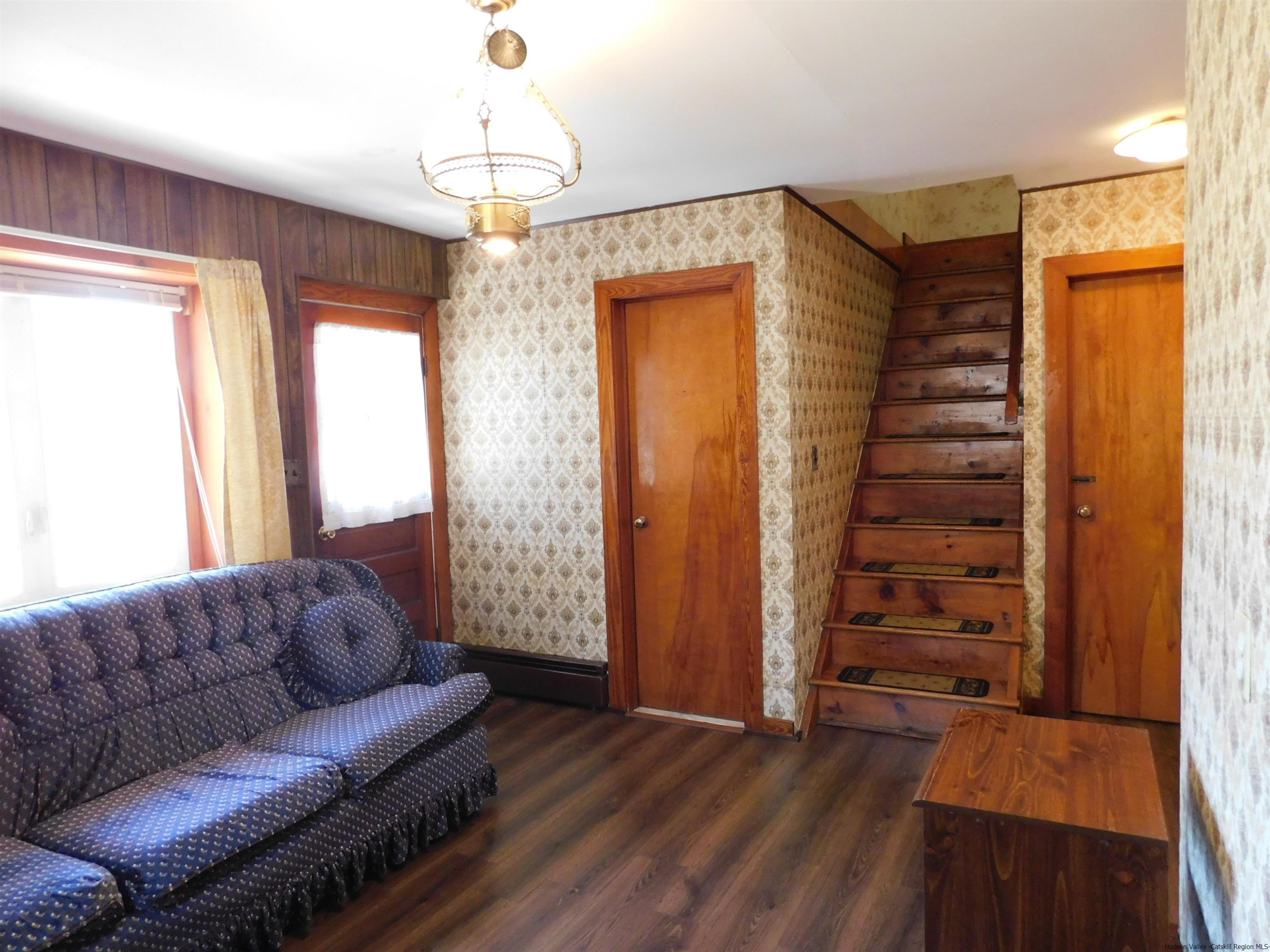 145 Sportsman Road Napanoch, NY 12458 - Photo 15 of 31 a living room with furniture and a chandelier