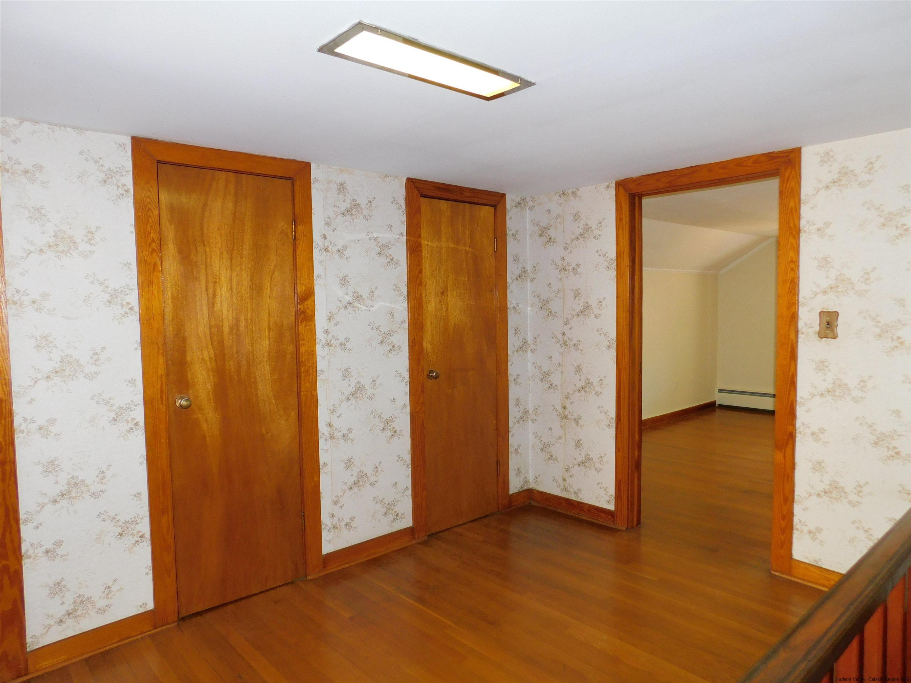 145 Sportsman Road Napanoch, NY 12458 - Photo 16 of 31 an empty room with wooden floor and windows