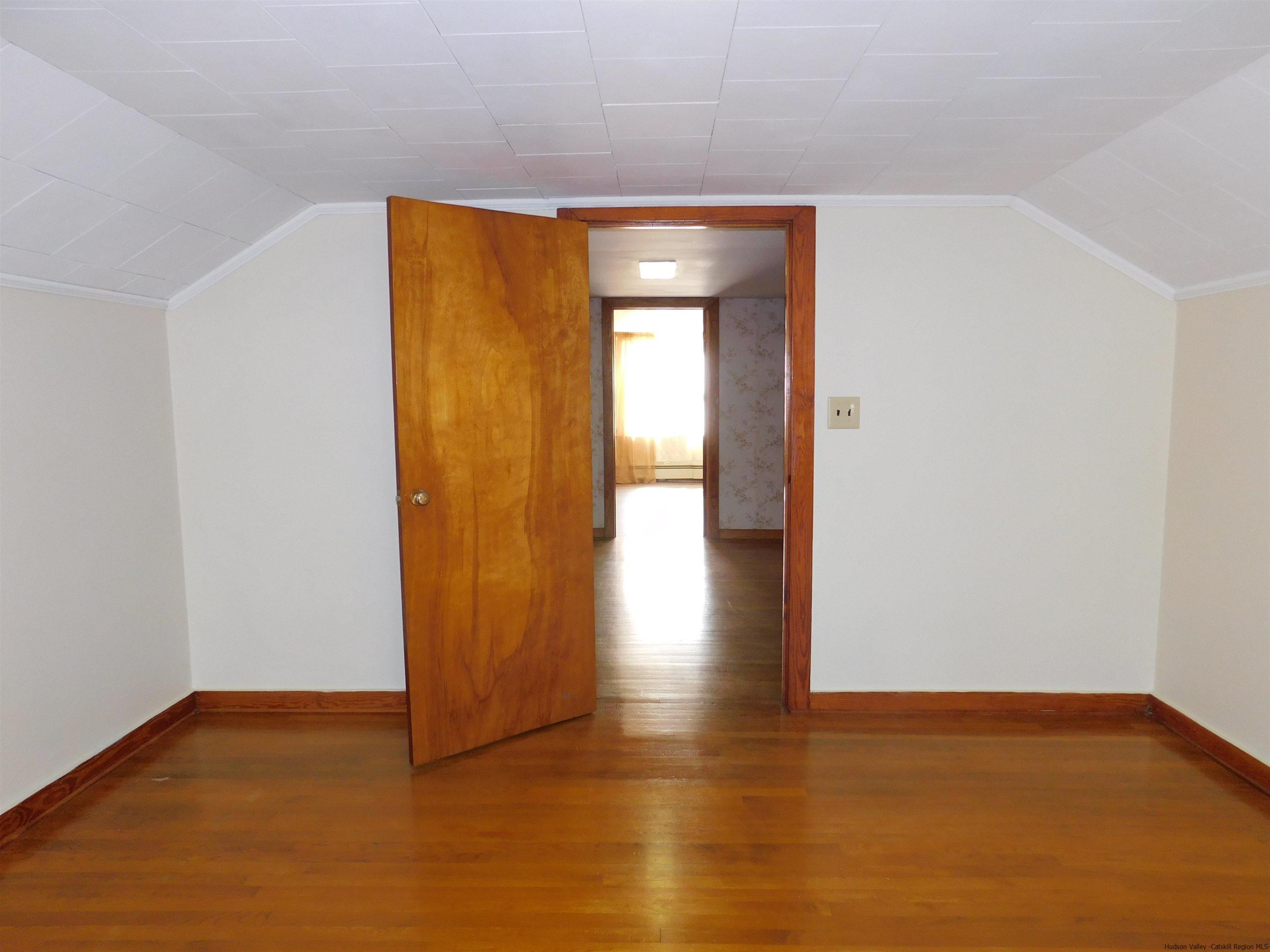 145 Sportsman Road Napanoch, NY 12458 - Photo 18 of 31 a view of an empty room with wooden floor and a window