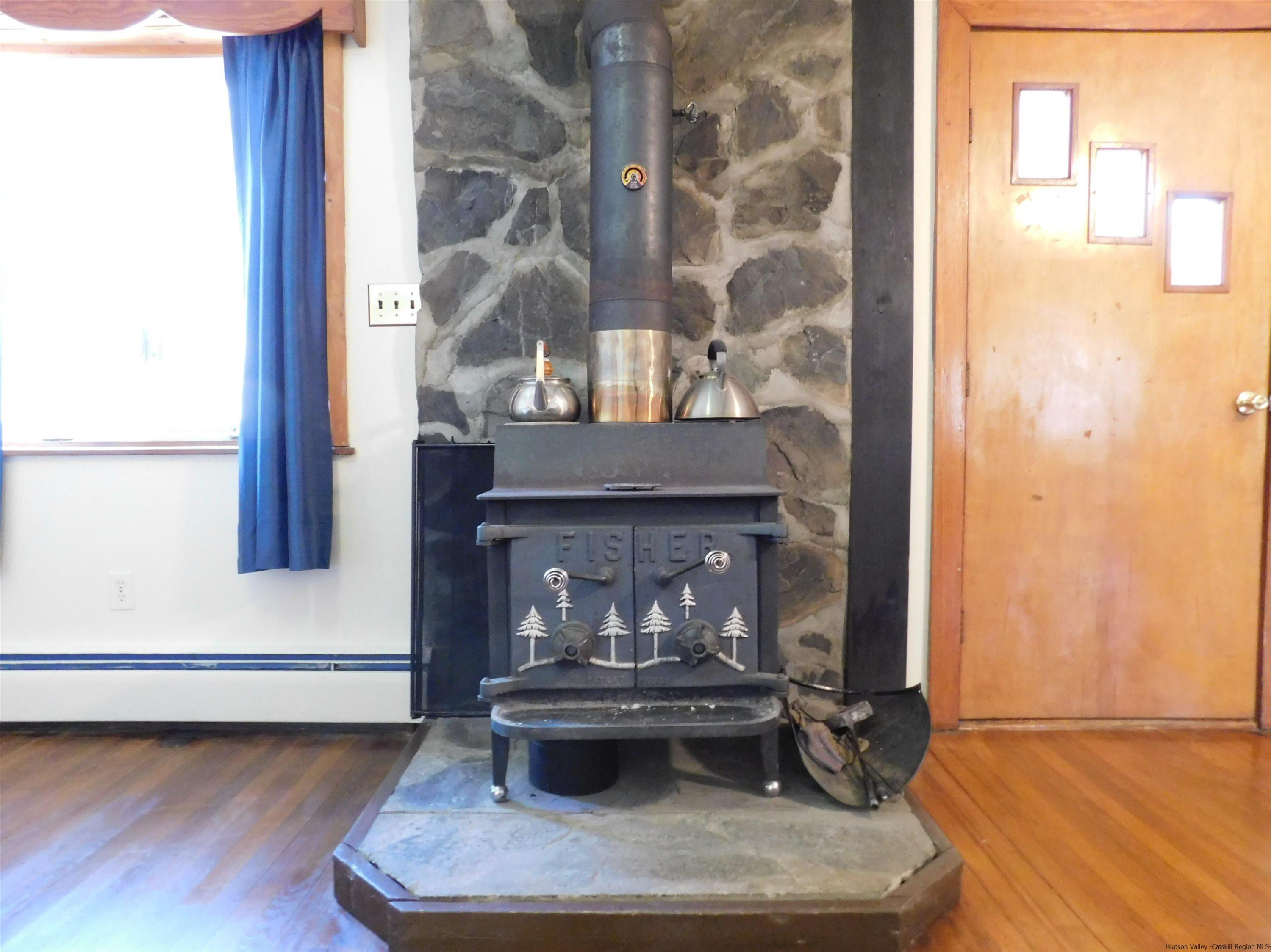 145 Sportsman Road Napanoch, NY 12458 - Photo 4 of 31 a living room with a fireplace and a window