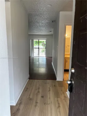 an entryway of a house with wooden floor
