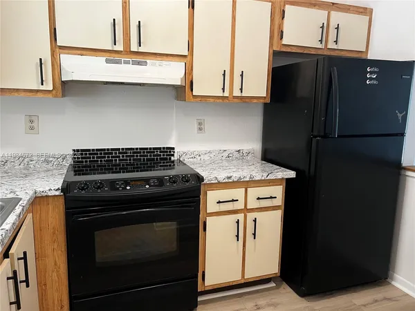 a kitchen with a stove and a refrigerator