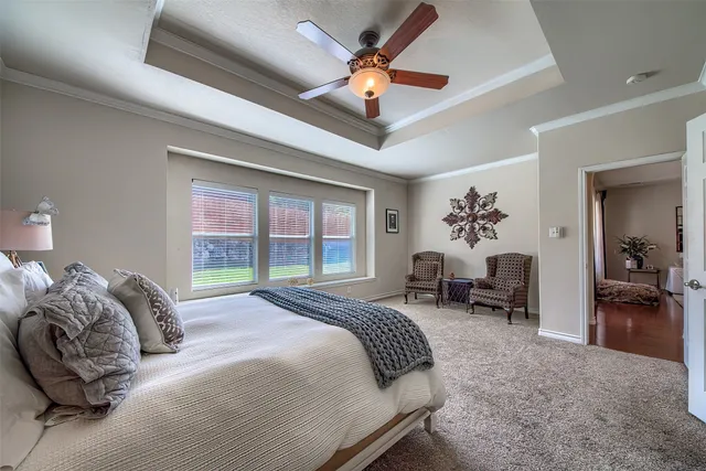 a bedroom with bed and a large window