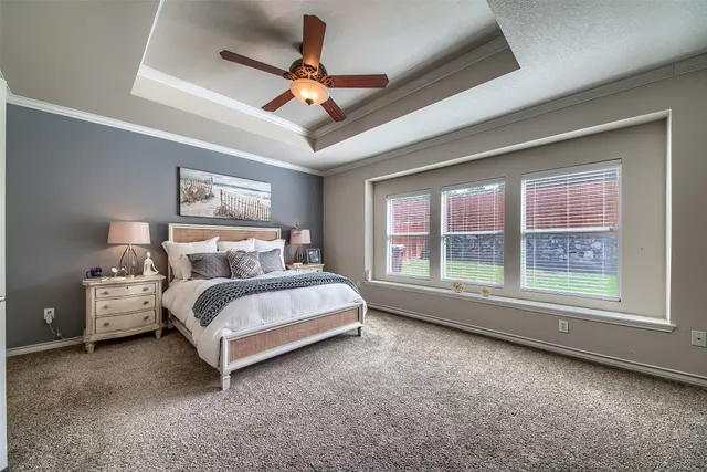 a spacious bedroom with a bed and a large window