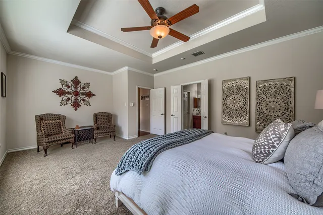 a bedroom with a bed furniture and a large window