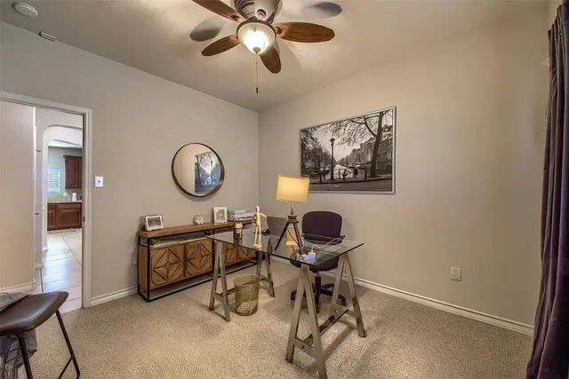 a view of a workspace with furniture and a window