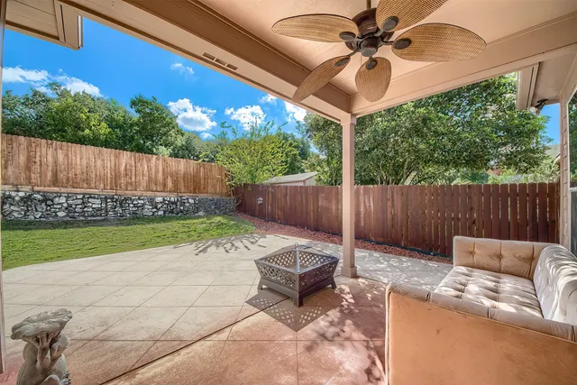 a backyard of a house with table and chairs