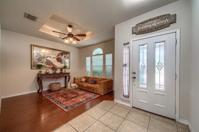 a living room with furniture a chandelier and a window