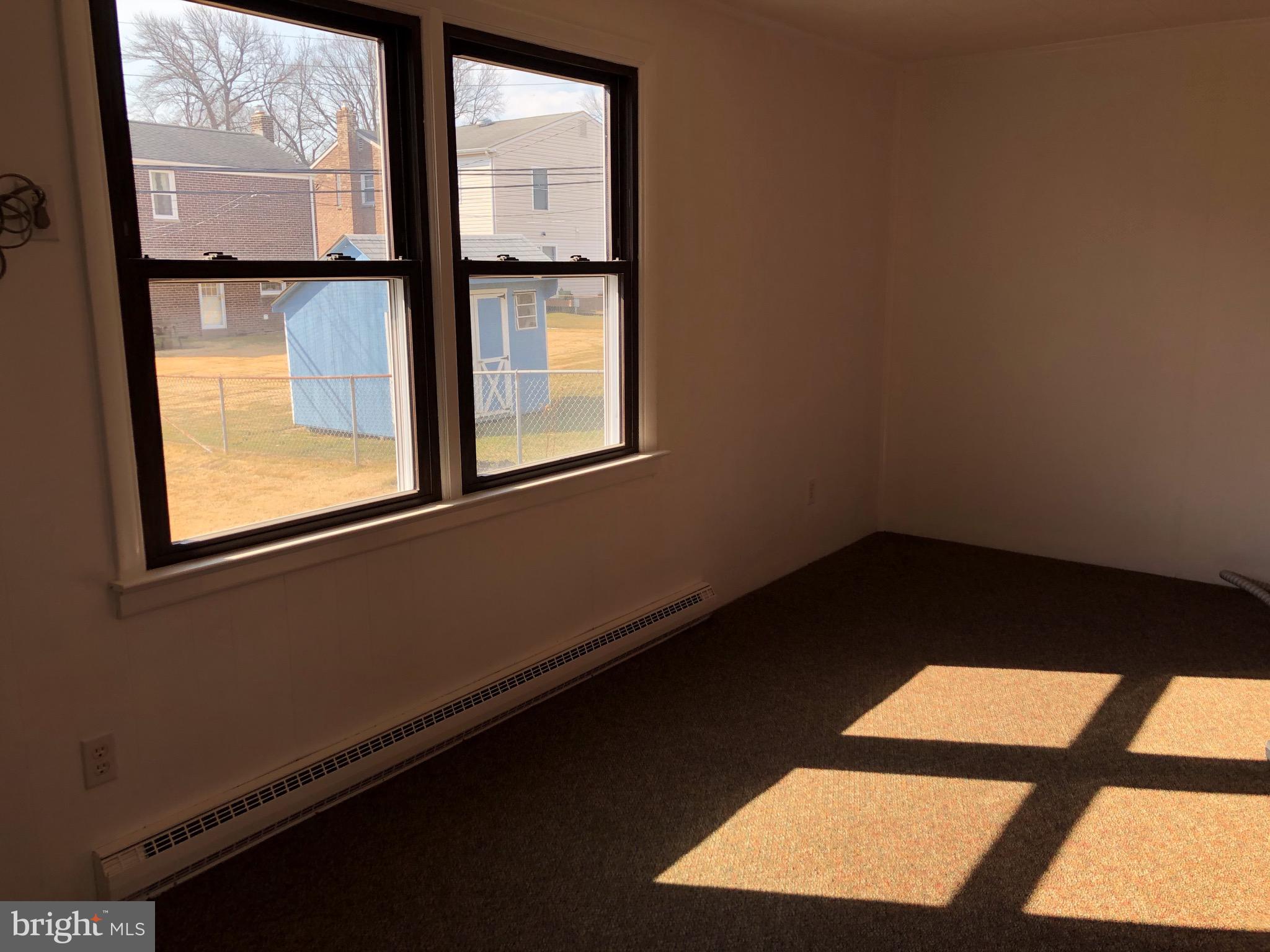 242 Potomac Road Wilmington, DE 19803 - Photo 10 of 24 Den with Carpeting and exposed brick wall