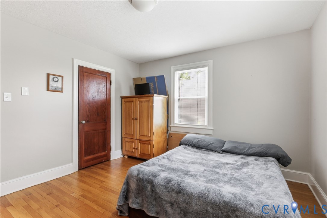 3510 East River Road Petersburg, VA 23803 - Photo 20 of 21 a bedroom with a bed and wooden floor