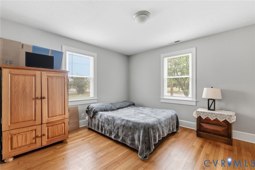 3510 East River Road Petersburg, VA 23803 - Photo 21 of 21 a bedroom with a bed and wooden floor