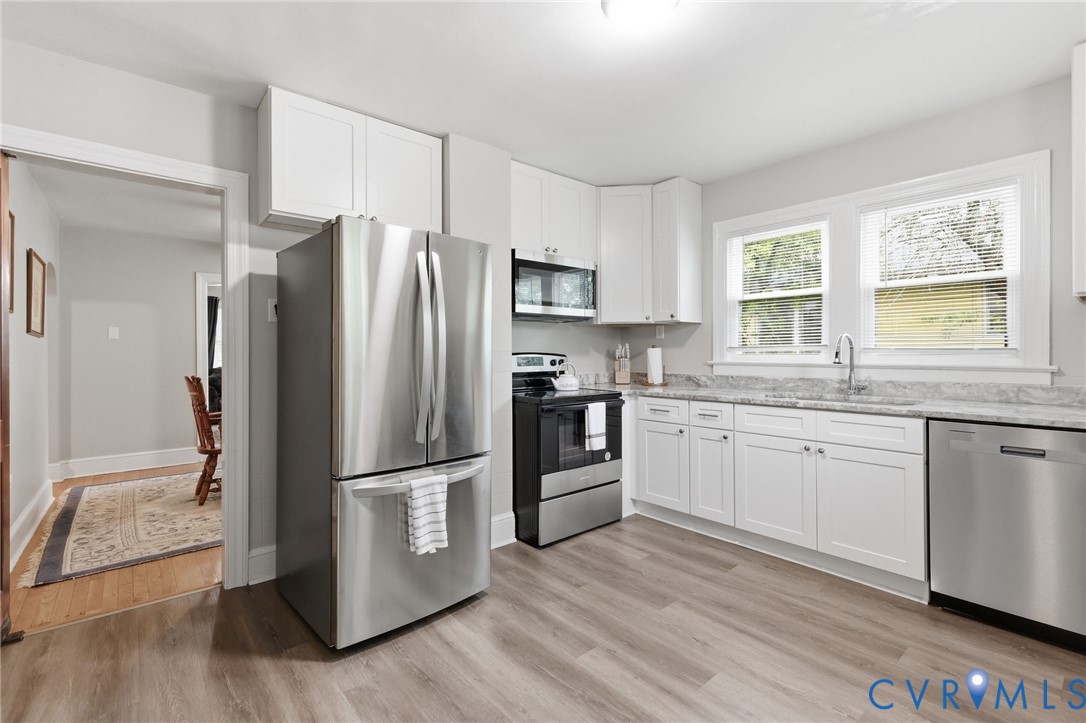 3510 East River Road Petersburg, VA 23803 - Photo 9 of 21 a kitchen with granite countertop stainless steel appliances a refrigerator cabinets and wooden floor