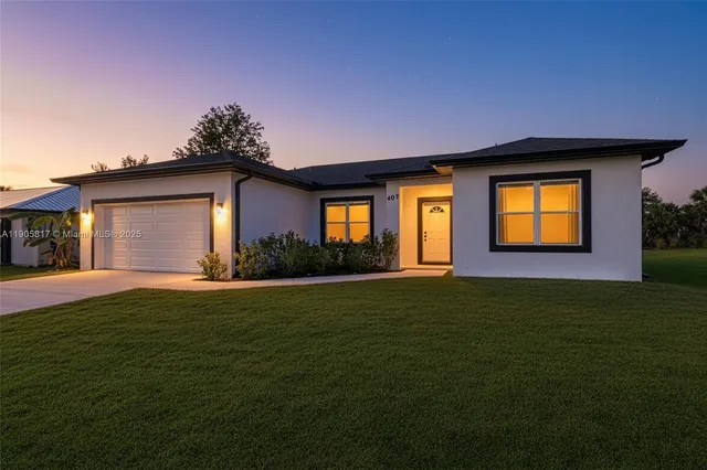 a front view of a house with a garden and yard