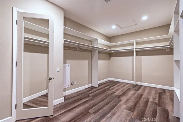 a view of walk in closet with clothes