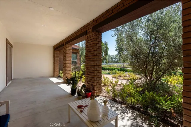 a view of a big room with wooden floor and windows