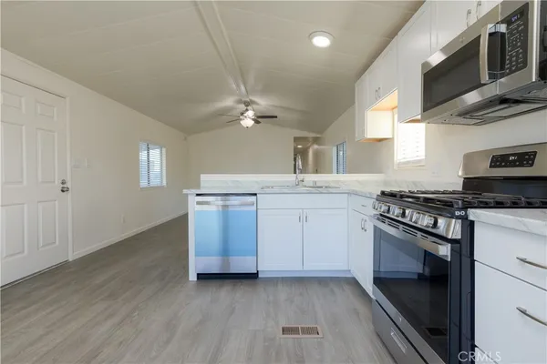 a kitchen with a sink stove and cabinets