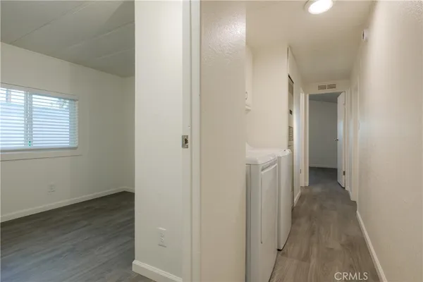 a view of a hallway with wooden floor