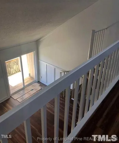 a view of staircase with wooden floor and stairs