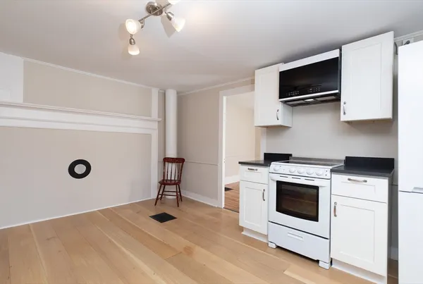 a kitchen with a stove and a microwave