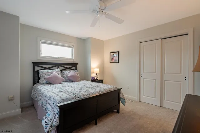 a bedroom with two beds and a chandelier