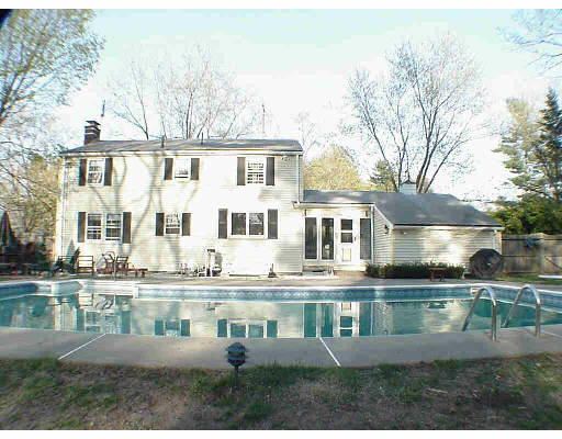 4 Peterson Road Natick, MA 01760 - Photo 3 of 3 a front view of a house with a yard and lake view