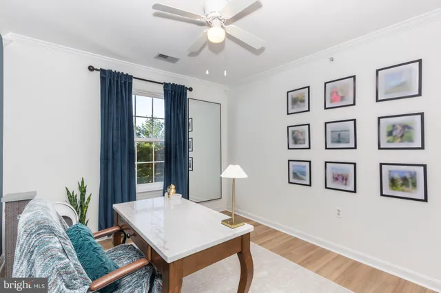 a view of a workspace with furniture and wooden floor