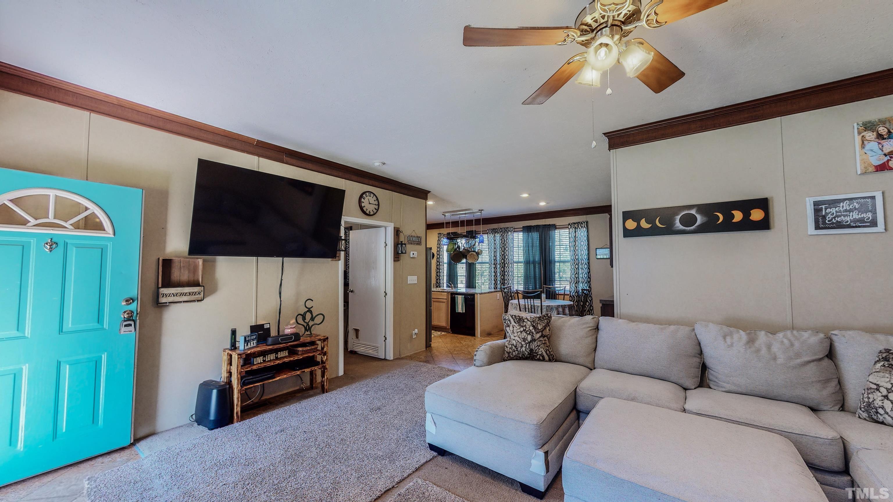 348 Wilbourne Run Roxboro, NC 27574 - Photo 3 of 25 a living room with furniture and a flat screen tv