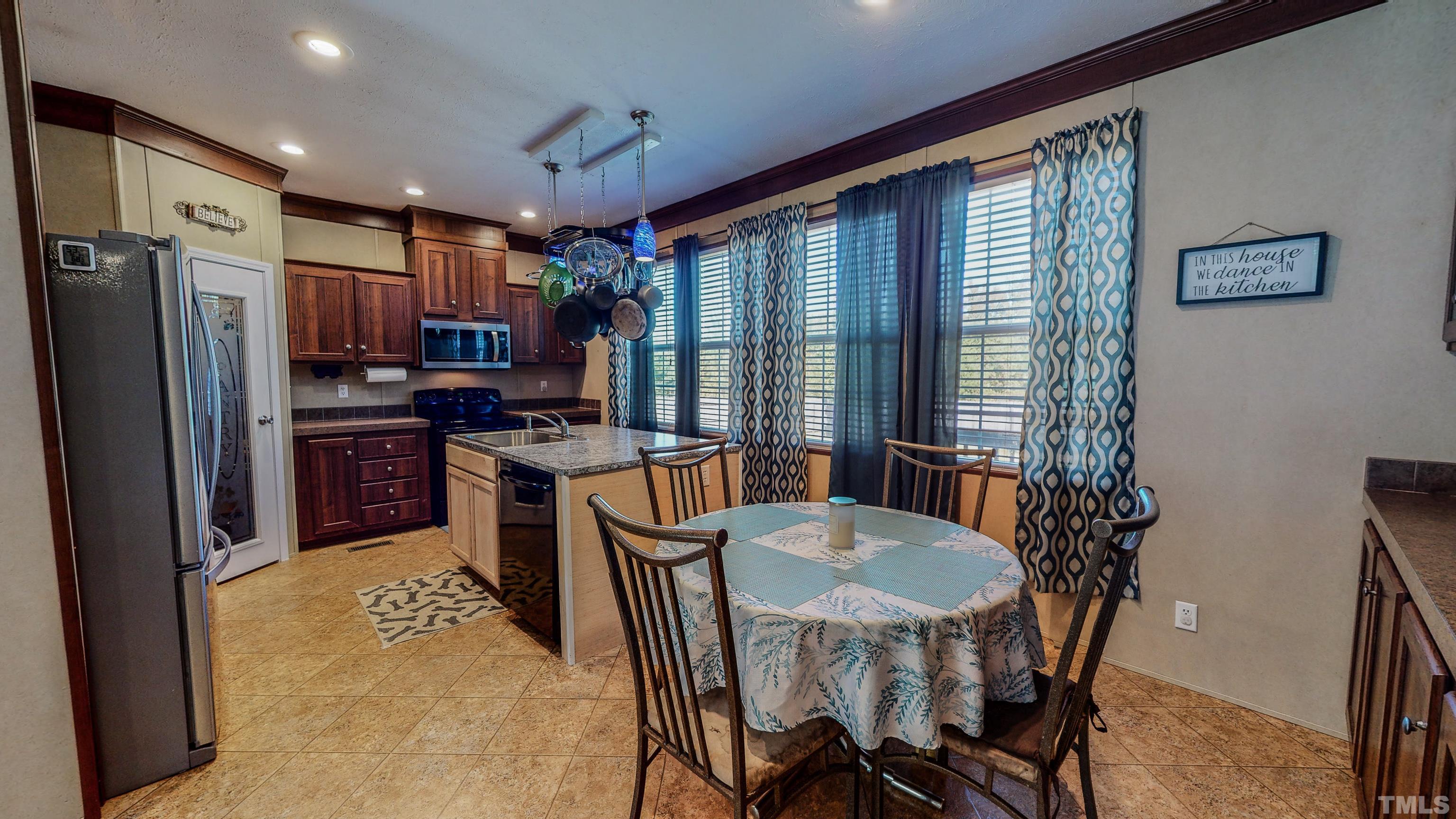 348 Wilbourne Run Roxboro, NC 27574 - Photo 4 of 25 a view of a dining room with furniture window and outside view