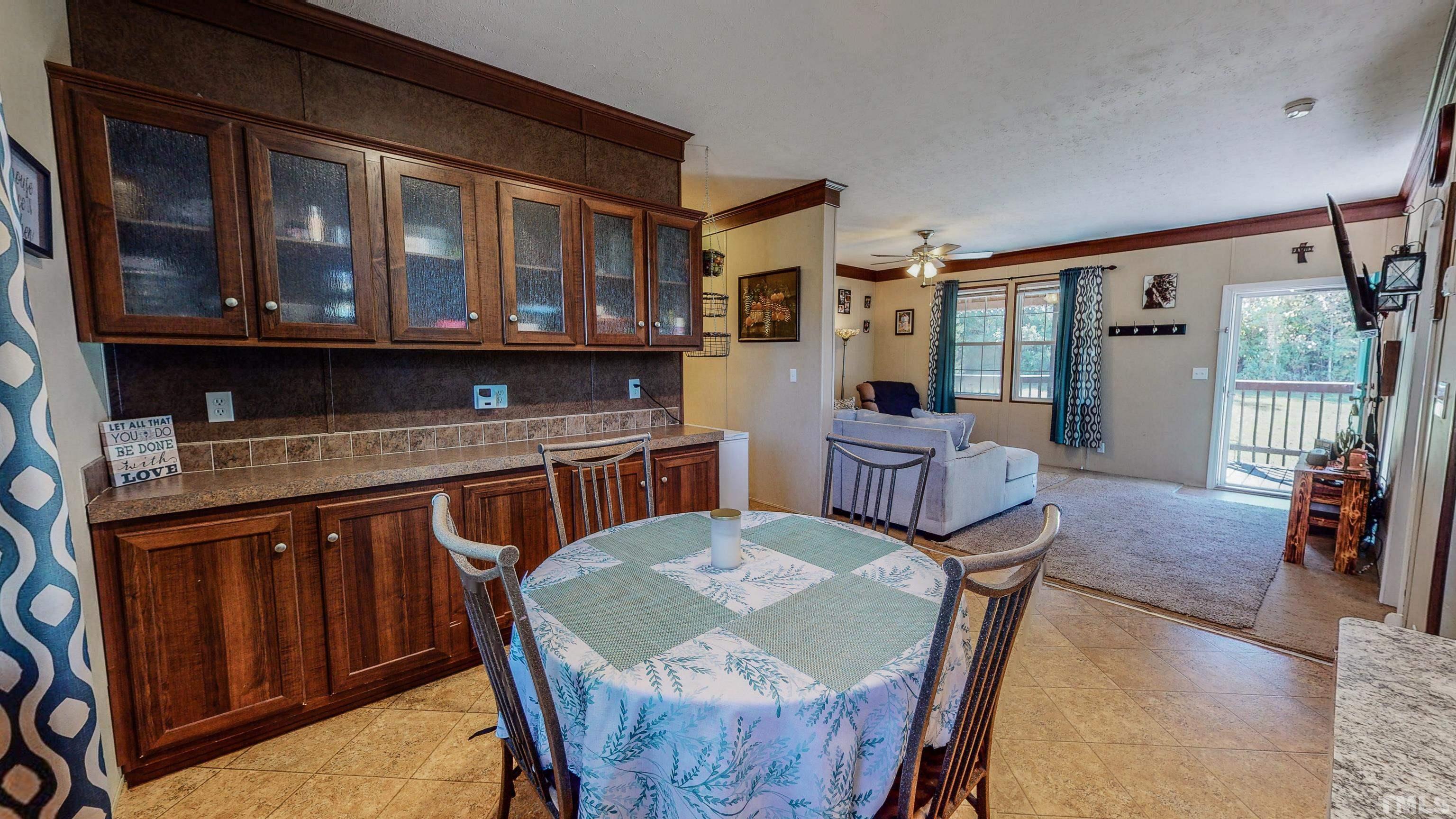 348 Wilbourne Run Roxboro, NC 27574 - Photo 5 of 25 a view of a dining room with furniture window and wooden floor