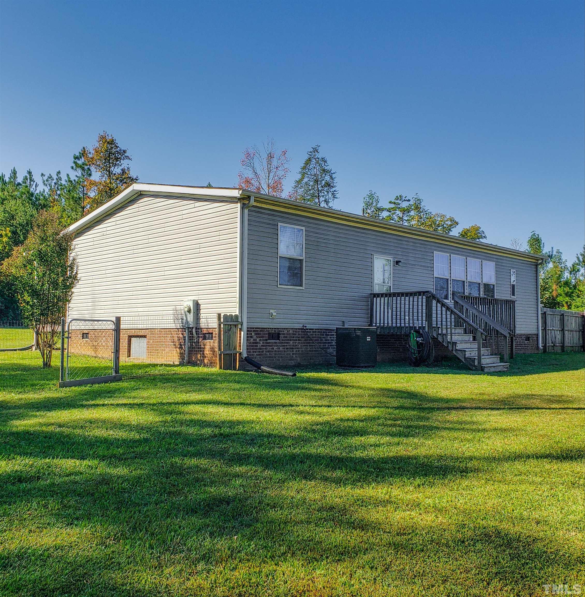 348 Wilbourne Run Roxboro, NC 27574 - Photo 9 of 25 a view of a house with a backyard